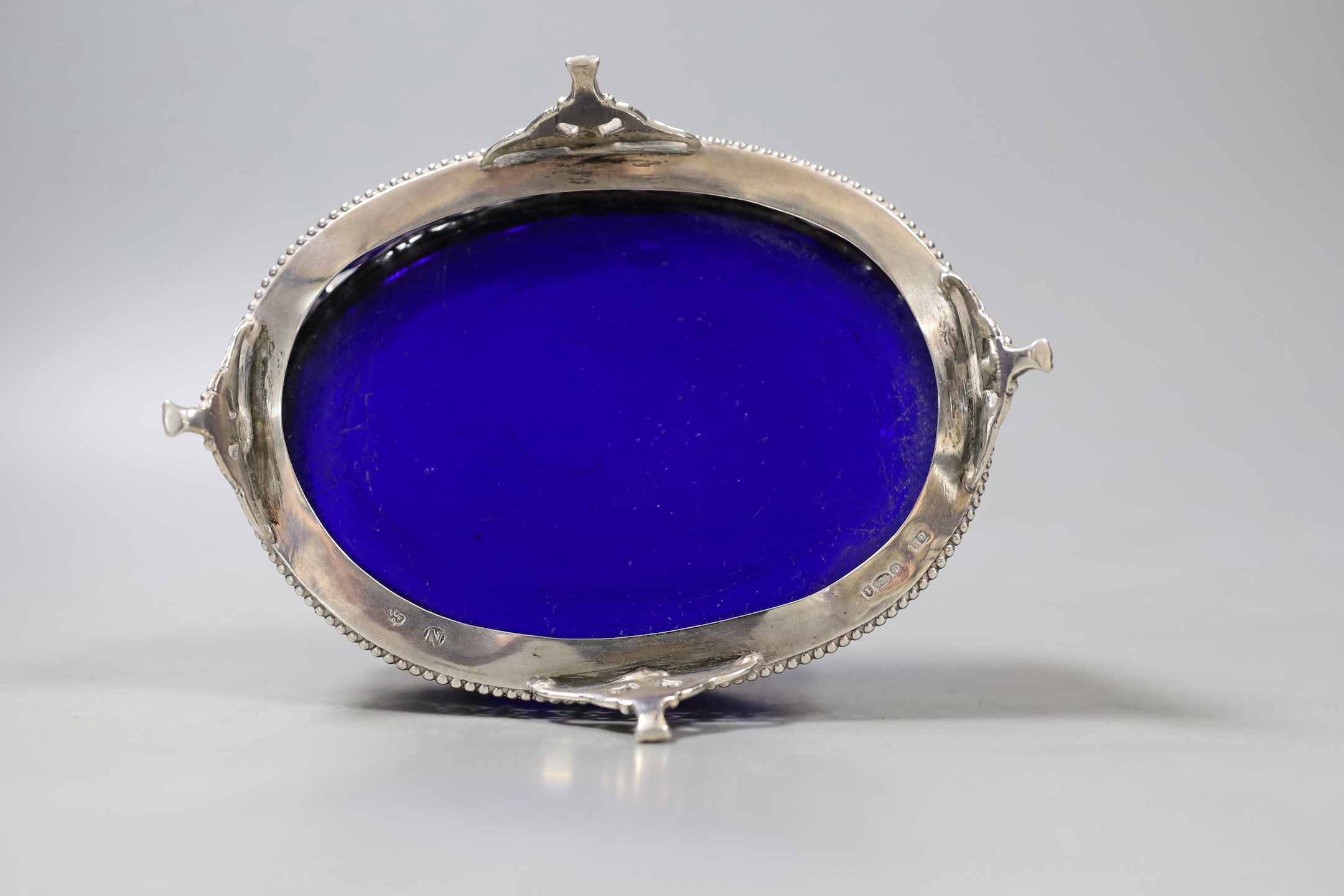 An early 20th century Hanau pierced silver oval bowl, with blue glass liner, import marks for London, 1906, 13.2cm.